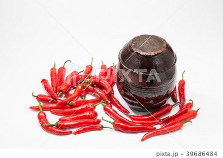 Chili peppers at Crock on white  39686484