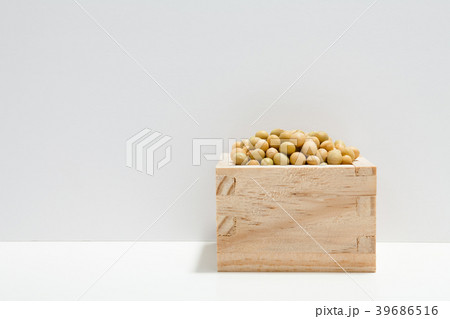 Soybeans in wooden bowl on white table 39686516