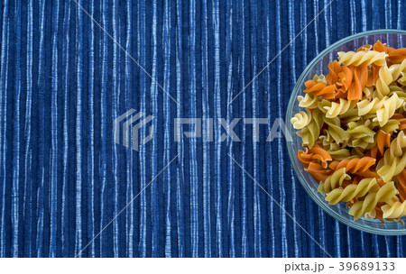 Multicolor spiral macaroni Pasta in a glass cup on Multicolor spiral macaroni Pasta in a glass cup on 39689133