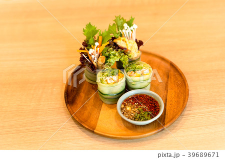 Vegetable salad roll on wooden plate with in sauce 39689671