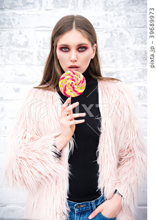 A girl with a multicolored lollipop A girl with a multicolored lollipop 39689973