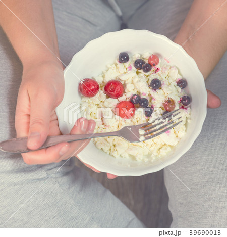 Full girl holding a plate of cottage cheese 39690013