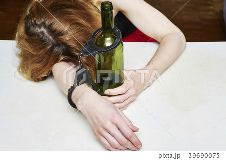 Girl asleep at a table 39690075