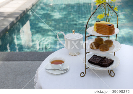 Afternoon tea with cup of tea and teapot and cake 39690275