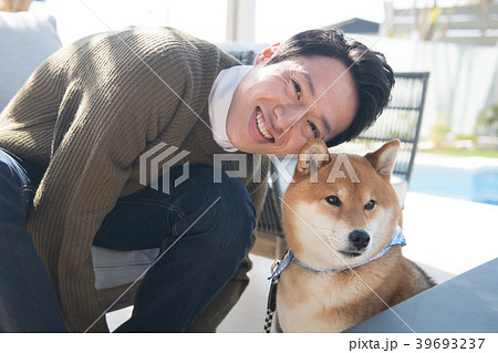 柴犬と若い日本人男性の写真素材