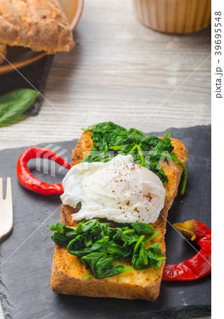 Toasted baguette with poached egg 39695548