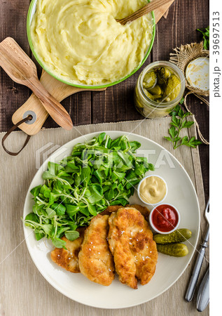 Schnitzel with mashed potatoes and salad 39697513