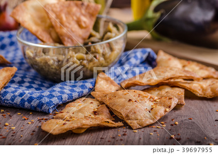 Homemade tortilla chips with garlic and eggplant dip 39697955