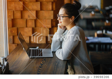 girl working on a laptop at a restaurant girl working on a laptop at a restaurant 39698166