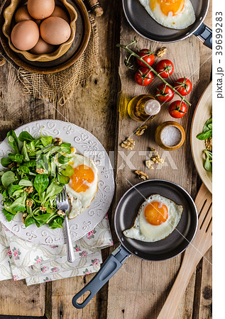 Fried eggs with salad and nuts 39699283