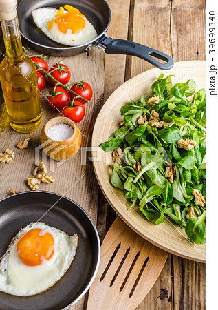 Fried eggs with salad and nuts 39699340