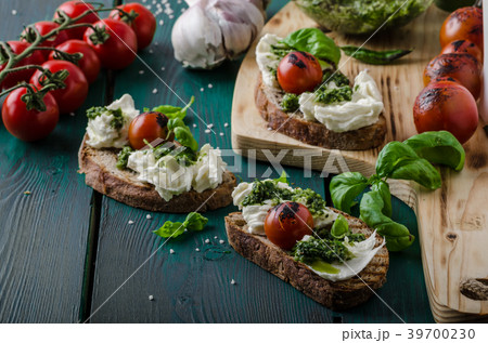 Grilled toasts with pesto Grilled toasts with pesto 39700230