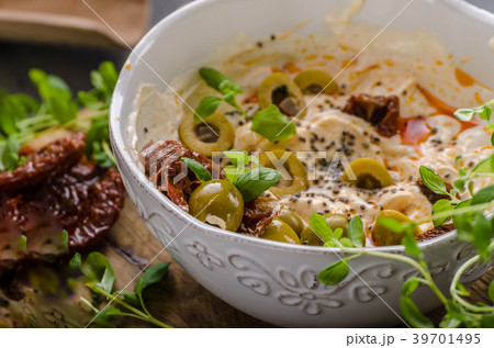 Fresh cheese with olives, dried tomatoes 39701495