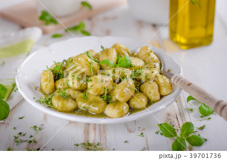 Pesto gnocchi, garlic and fresh herbs olive oil 39701736