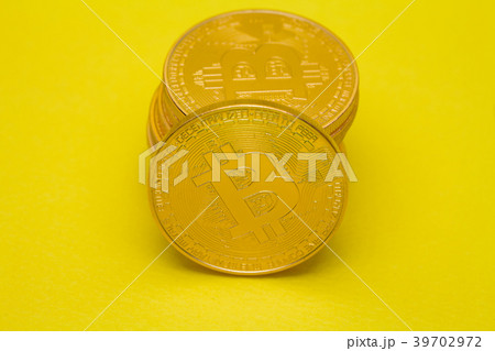 Stack of golden bitcoin on yellow brown concept Stack of golden bitcoin on yellow brown concept 39702972