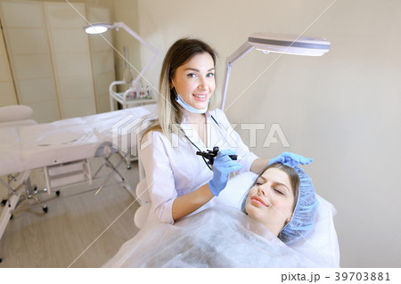 Young woman lying at cosmetology cabinet and 39703881