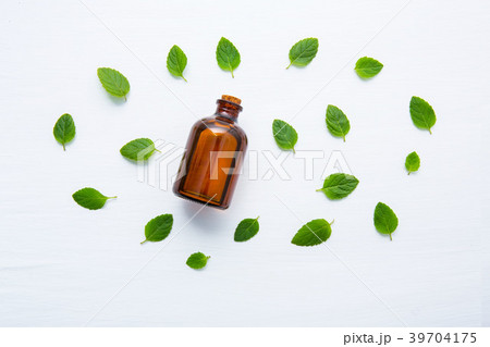 Natural Mint Essential Oil in a Glass Bottle. Natural Mint Essential Oil in a Glass Bottle. 39704175