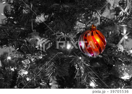 A single, red bauble, hanging on a Christmas Tree 39705536