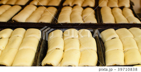 Sweet pastry going to the oven. Sweet pastry going to the oven. 39710838