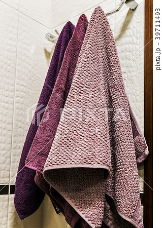 towels of different colors hanging on a hanger  39711493