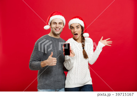 Christmas concept - Happy young couple in Christmas concept - Happy young couple in 39715167