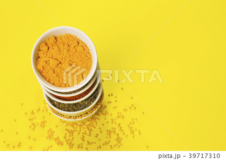 Various spices in bowls on yellow background. Copy Various spices in bowls on yellow background. Copy 39717310