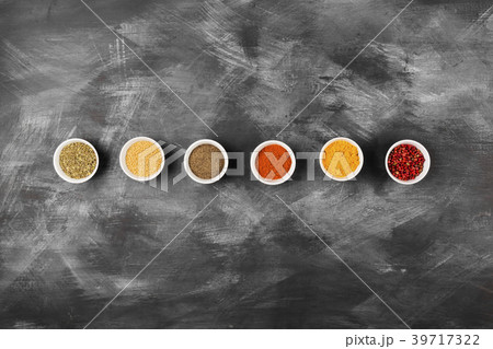 Various spices in bowls on black background Various spices in bowls on black background 39717322