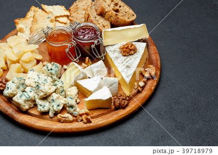 Brie cheese on a wooden Board with bread and sweet Brie cheese on a wooden Board with bread and sweet 39718979