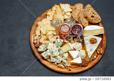 Brie cheese on a wooden Board with bread and sweet 39718983