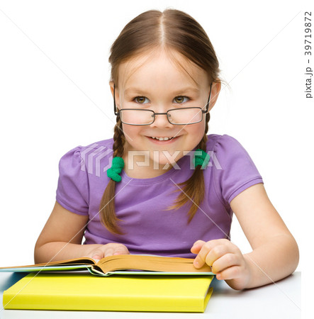 Cute cheerful little girl reading book 39719872