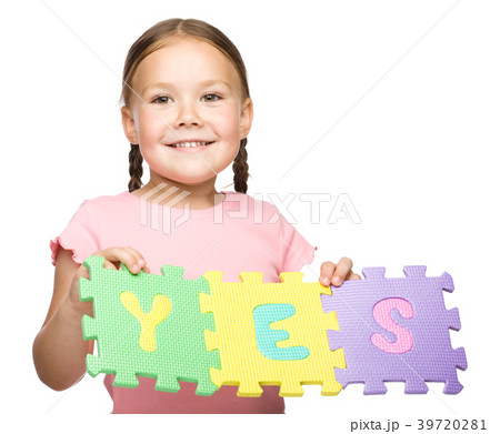 Cute little girl is holding Yes slogan 39720281