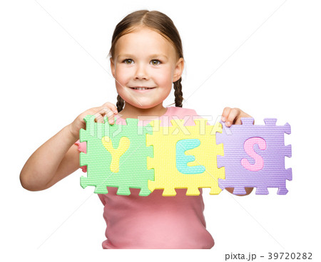 Cute little girl is holding Yes slogan Cute little girl is holding Yes slogan 39720282