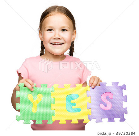 Cute little girl is holding Yes slogan Cute little girl is holding Yes slogan 39720284