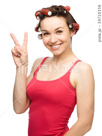Woman is showing victory sign 39720356