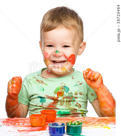 Child is grabbing some paint using fingers Child is grabbing some paint using fingers 39720464