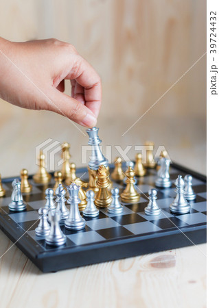Hand of woman moving king silver chess Hand of woman moving king silver chess 39724432