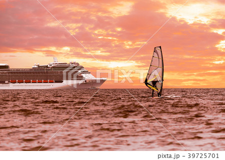 Windsurfer in the sea with a cruise ship Windsurfer in the sea with a cruise ship 39725701