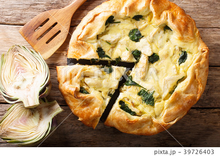 tasty pie with artichokes and spinach close-up 39726403