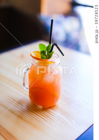 Glass of orange juice on wooden table in 39728523