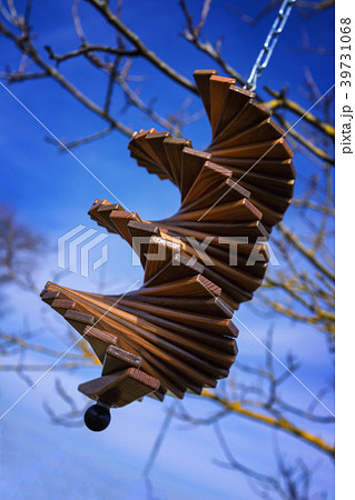 Wooden wind chime in front of a blue sky Wooden wind chime in front of a blue sky 39731068