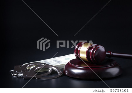 Wooden judge gavel and police handcuffs 39733101