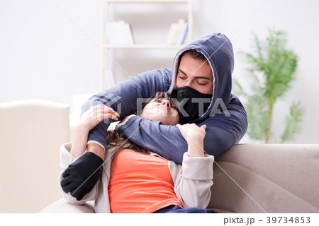 Armed man assaulting young woman at home Armed man assaulting young woman at home 39734853