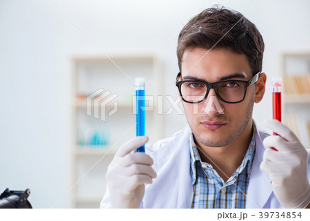 Young chemist student working in lab on chemicals Young chemist student working in lab on chemicals 39734854