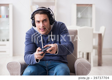 Young man playing computer games at home 39737704