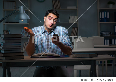 Student preparing for exams late at night 39737904