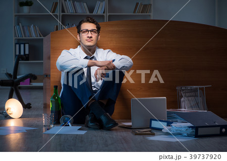 Stressed businessman working overtime in Stressed businessman working overtime in 39737920