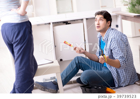 Husband repairing broken table at home 39739523