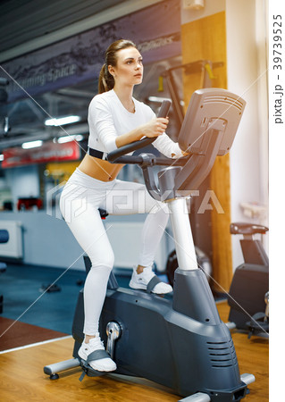 Indoor cycling woman doing cardio workout biking 39739525
