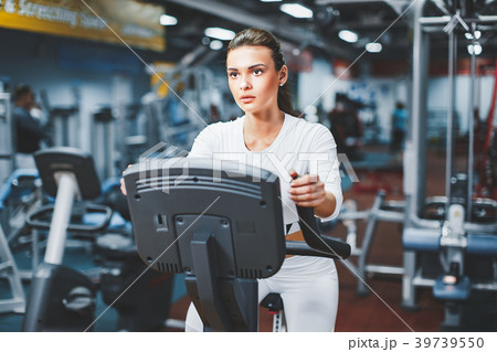 Indoor cycling woman doing cardio workout biking 39739550