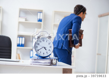 Businessman in bad time management concept Businessman in bad time management concept 39739633